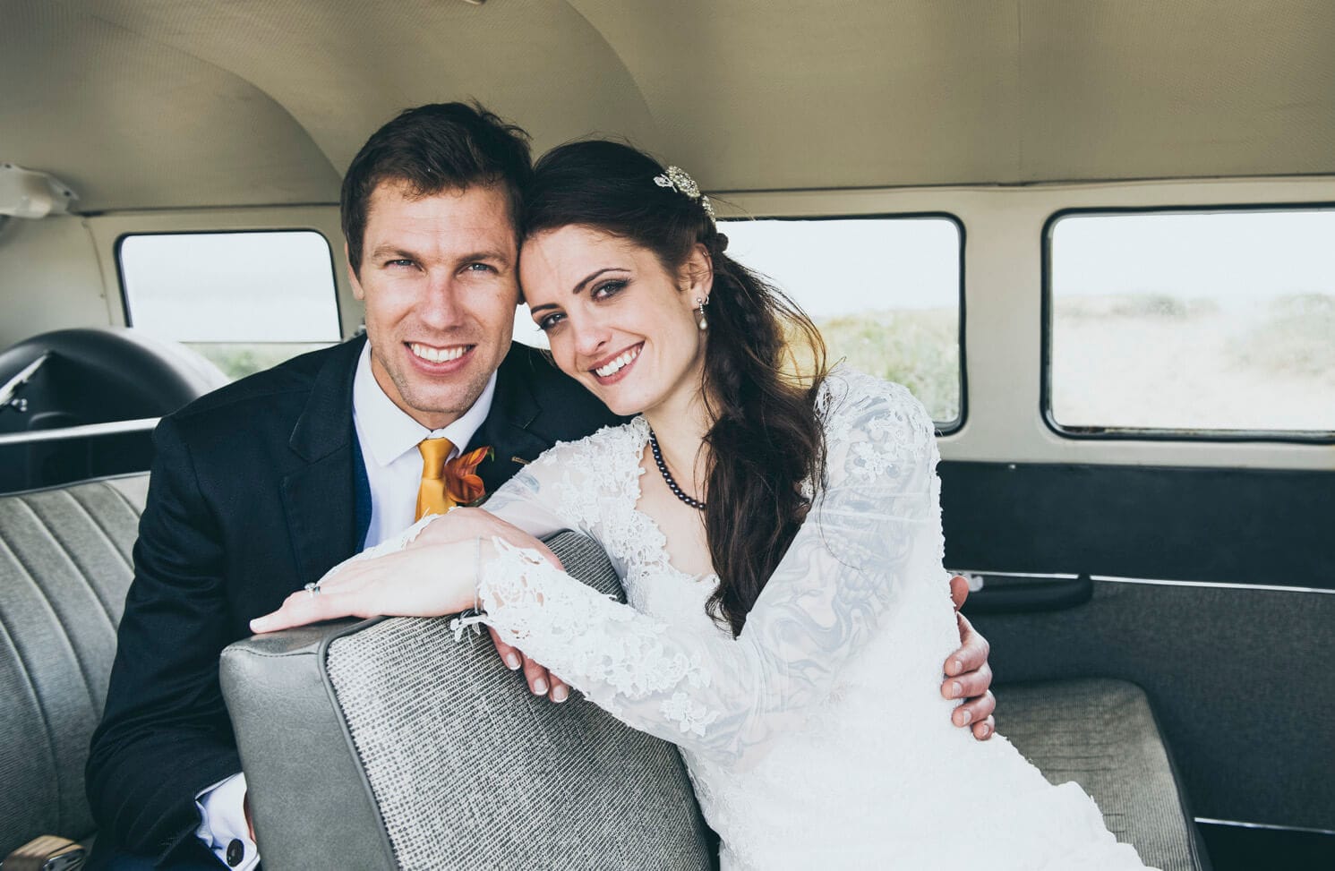 Bride and groom inside camper van