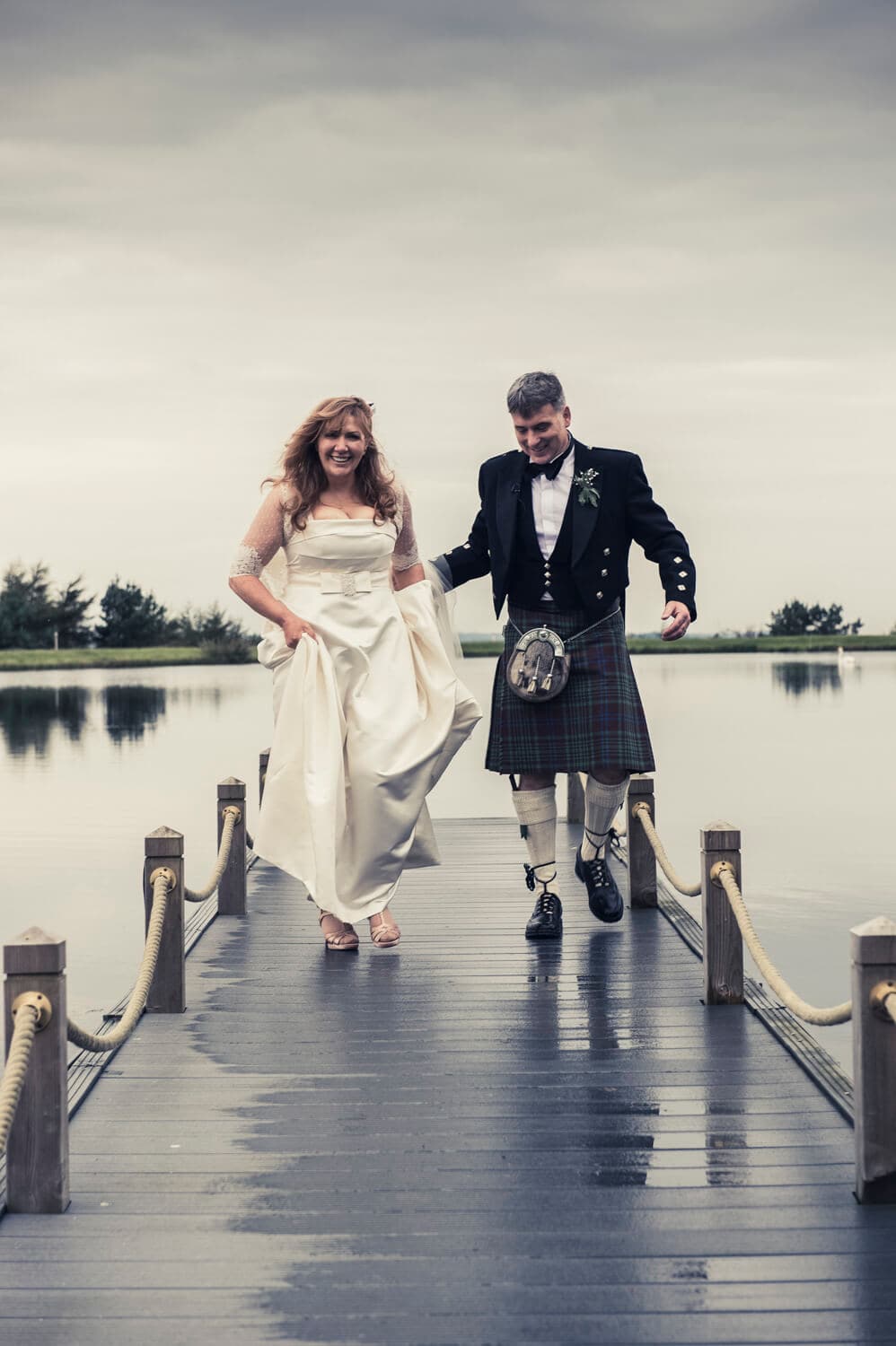 Bride and groom running towards camera