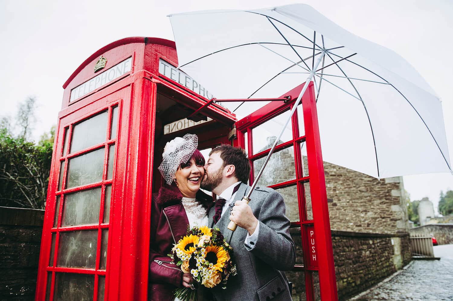 Wedding photograph of Bride and Groom outside phone box by Ayrshire wedding photographer Richard Campbell