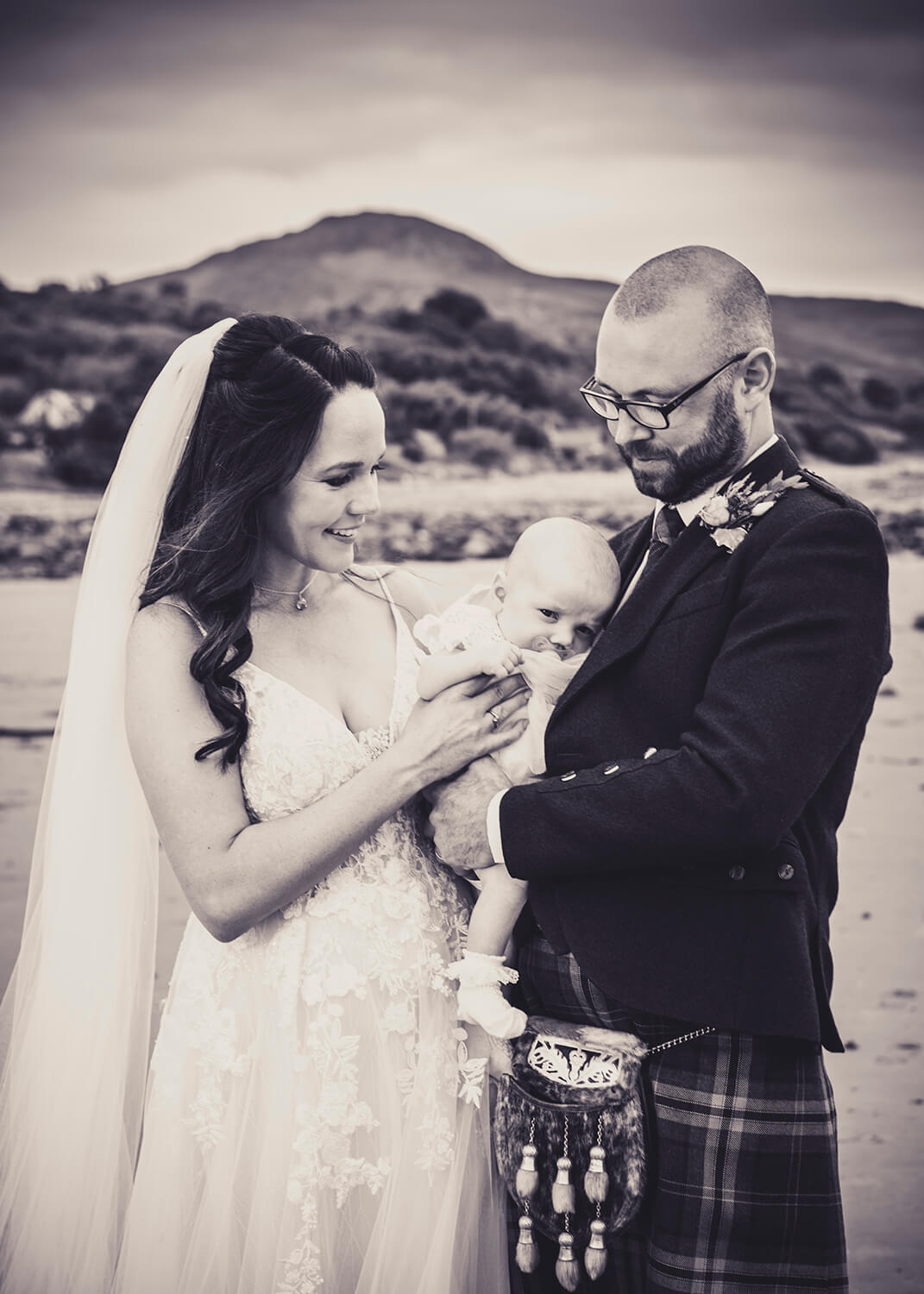 Bride and Groom with baby daughter on Whiting Beach Isle of Arran