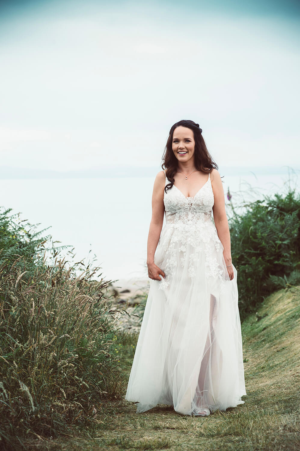 Bride walking back from Whiting Bay beach on the Isle of Arran by Ayrshire Wedding Photographer Richard Campbell